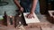 Luthier creating a guitar and using tools in a traditional