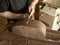 Luthier makes a neck block on classical guitar.