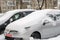 Lutsk, Ukraine - February 12,2020: City street after blizzard. Stuck car in snow and ice. Buried vehicle in snowdrift