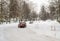 Lutsk, Ukraine - February 12,2020: City street after blizzard. Stuck car in snow and ice. Buried vehicle in snowdrift. Parking in
