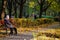 Lutsk, Ukraine - November 8, 2020. Caucasian older women sitting on bench in autumn park.