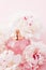 Luxe fragrance bottle as girly perfume product on background of peony flowers, parfum ad and beauty branding