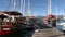 Luxe rich wooden yachts stand on background of blue sky in harbor of Turkey.