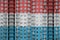 Luxembourg flag depicted in paint colors on multi-storey residental building under construction. Textured banner on brick wall