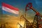 Luxembourg oil industry concept. Industrial illustration - Luxembourg flag and oil wells against the blue and yellow sunset sky