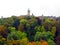 Luxembourg, view of the city from afar. Autumn green, red, yellow trees, spiers of towers of old houses in the distance.