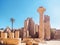 Luxor, Egypt - February 2020: columns and ruins of Karnak Temple, long view. A lot of tourists seeing the sights. Blue