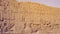 Luxor Egypt karnak temple behind big wall craved with hieroglyphics of god and pharaoh large size