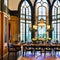 A luxurious, art nouveau dining room with stained glass windows, ornate furnishings, and nature-inspired motifs1, Generative AI