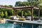 Luxurious backyard with pool and lounge area under pergola.