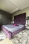 Luxurious bedroom with a violet king size bed