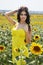 Luxurious brunette in a yellow dress with flowers