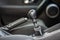 Luxurious car black leather interior. Handbrake manual brake and gearshift stick on blurred background. Transportation, design,