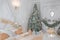 Luxurious Classic Bright White Bedroom Interior with Christmas New Year Tree decor and lights