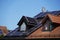 Luxurious country house with a large dormer window. New solar modules have been installed on the light bricks