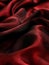 Luxurious deep red satin silk fabric, elegantly draped with soft, smooth textures and rich folds.