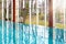 Luxurious empty infinity swimming pool with big glass windows.
