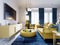 Luxurious fashionable living room with yellow upholstered furniture and blue carpet and decor, white walls