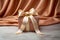 Luxurious gift tied with satin ribbon with bow on background of peach fabric. Beautiful drapery. Gift for any holiday