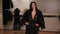 A luxurious girl with long hair tries on a fur coat in a women`s clothing store.