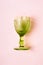 Luxurious green Vintage Wine Glass on pastel pink background