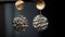 Luxurious Hammered Gold Earrings On Branch: Intense Lighting And Shadow