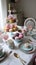 Luxurious high tea party in a classic elegant interior with sweets and tea, tablescape, tea table setting. Generative Ai