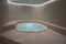 Luxurious Indoor Jacuzzi with Beige Marble Tiles, Tranquil Lighting