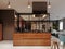 Luxurious kitchen modern style with wooden contemporary furniture and island with hood. Burgundy gray walls, black granite