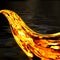 Luxurious, mysterious, vintage splash of golden liquid on a black background. Gold flow