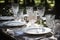 luxurious outdoor table setting with fine china, crystal glasses, and silverware