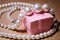 Luxurious pearl jewelry on a pink box. Snow-white pearls. Bijouterie. Jewelry. Pearl beads. Women`s jewelry.