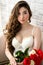 Luxurious portrait sensual woman in white lingerie with bouquet roses in hands