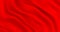 Luxurious red smooth fabric background with waves. Wavy folds of a noble textile background. Red matte fabric flutters in the wind