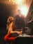 Luxurious sexy blonde woman pianist playing piano, party concert dark gothic scene, elegant man in black suit listens to