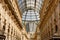 Luxurious shopping center Vittorio Emanuele II from inside the arcade. City of Milan, Italy