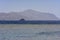 Luxurious snow-white motor yacht in the Red Sea against the blue sky and ancient high corals on the shore