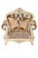 Luxurious soft armchair upholstered in expensive beige brocade and velor fabric, isolated on a white background