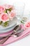 Luxurious table setting with pink roses