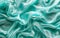 Luxurious teal green satin fabric draped in soft, sinuous waves that accentuate the rich sheen and fluid texture.