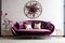 a luxurious velvet art deco sofa against a white wall