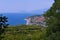 Luxurious view from the mountain on the coast with houses and resort infrastructure located at the foot and the endless
