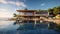 Luxurious villa with an infinity pool seamlessly merging with the vast expanse of the ocean, creating an atmosphere of relaxation