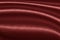 Luxurious wavy red fabric texture surface curtain wave with a pattern background. macro texture of red striped fabric