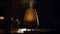 A luxurious wine bottle illuminated by candlelight on a wooden table generated by AI