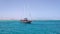 A luxurious wooden sailboat in the Red Sea against the blue sky