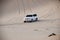Luxurous white SUW 4x4 on desert safari on dunes exreme racing in arabia travel rally on sand in sports vehicle all