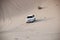 Luxurous white SUW all wheel drive 4x4 on desert safari on dunes exreme racing in arabia travel rally on sand in sports