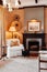 Luxury African Safari lodge living room interior with vintage white armchair, lamp, old wood table  and fireplace