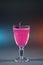 luxury alcohol pink cocktail drink with basil in glass on grey background